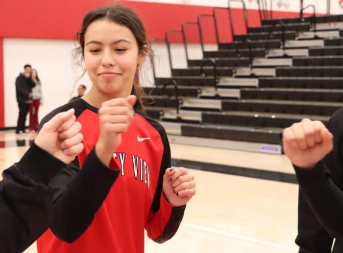 Ari Long fist bumps with the referees before the Xavier Prep game. Photo: John Murphy